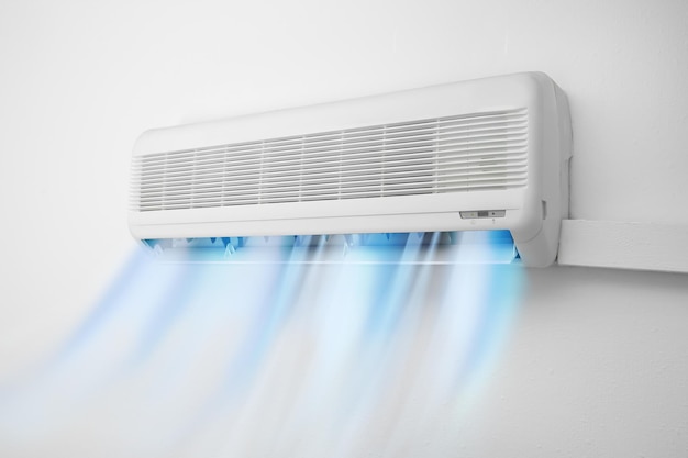 Photo modern conditioner and illustration of cool air flow on white wall indoors