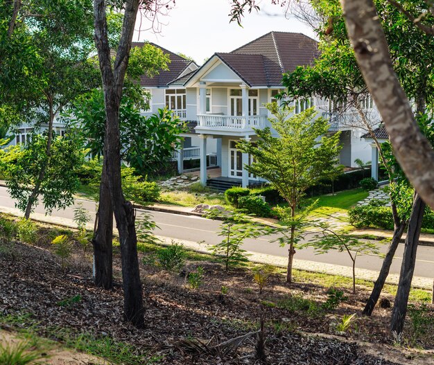 Modern cottages row road sidewalk two story buildings residential villas village New Estate Reflection dawn Sun in windows