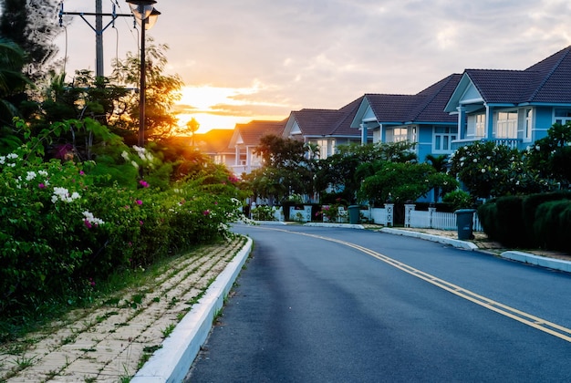 Modern cottages row road sidewalk two story buildings residential villas village New Estate Reflection dawn Sun in windows