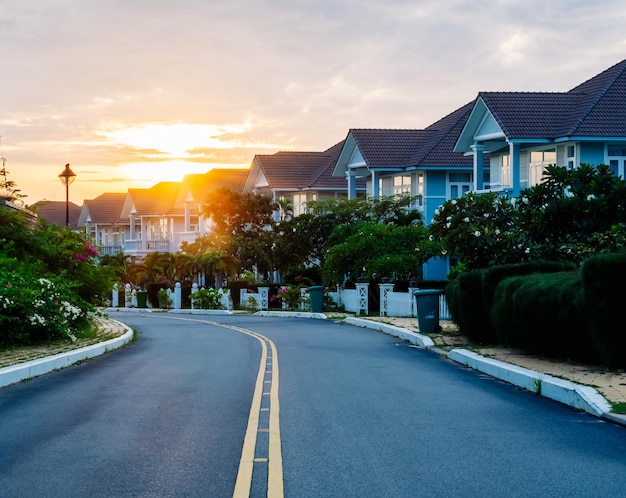 Modern cottages row road sidewalk two story buildings residential villas village New Estate Reflection dawn Sun in windows