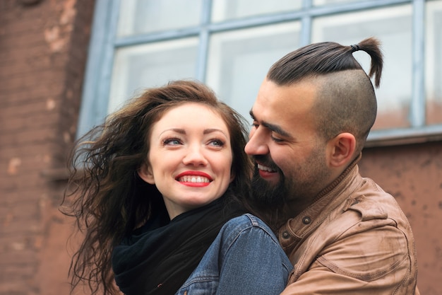 Modern couple in love standing on the street of the city