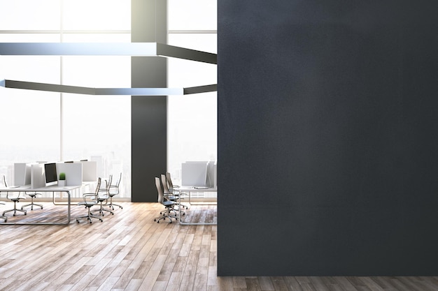Modern coworking office room with blank black wall