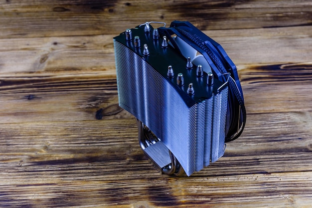 Modern cpu cooler with heat pipes on a wooden background