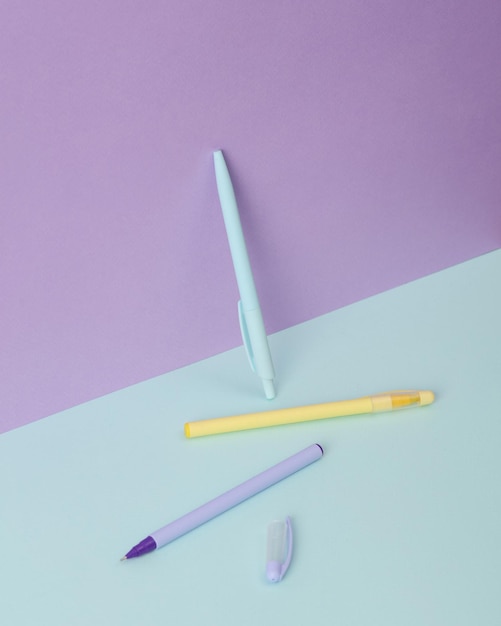 modern and creative composition with multicolored pens on a two tone pastel background minimal still life business education concept