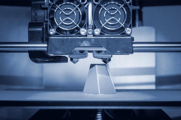Modern d printer printing figure closeup automatic three dimensional d printer performs plastic gray