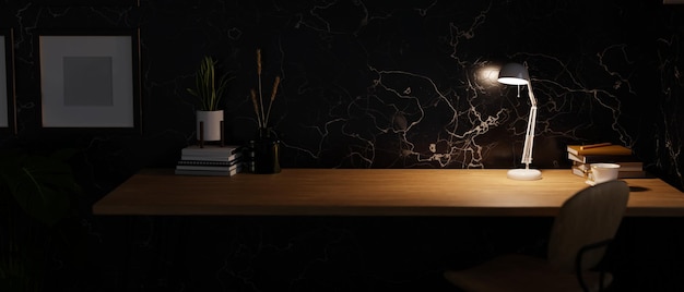 Modern dark home workspace with copy space on wooden tabletop\
under warm light from table lamp