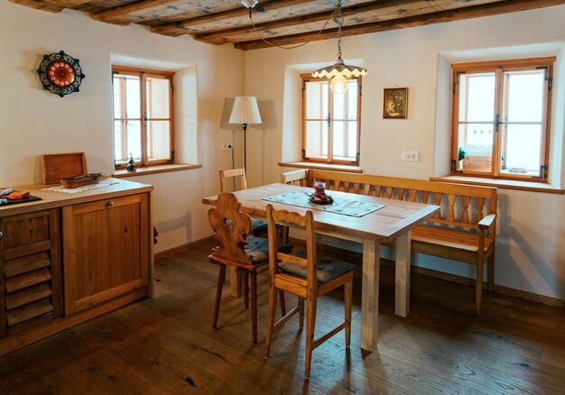 Modern design of Home Kitchen Interior made of wood materials. Wooden furniture in house. Dining room. Brown color. Table and chair. Window on background. Contemporary rustic and vintage handmade