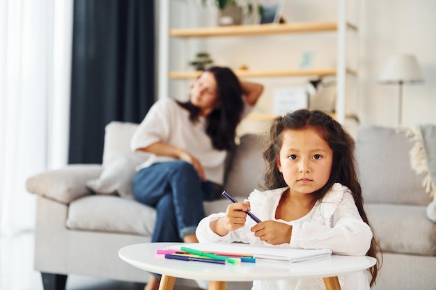 Modern design Mother and her daughter spending time together at home