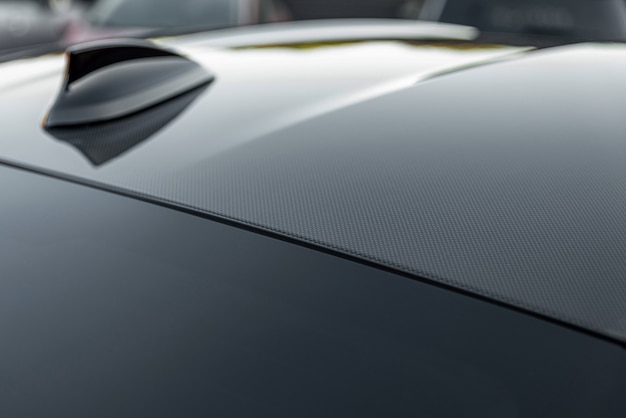 Modern design sport car radio antenna also known as shark fin Close up carbon fibre car roof