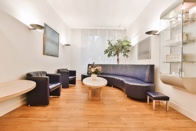 Modern desk and chair located in spacious home office with\
white walls in light house