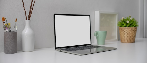 Modern desk with laptop with white screen