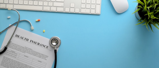 Modern desk with stethoscope and medical documents