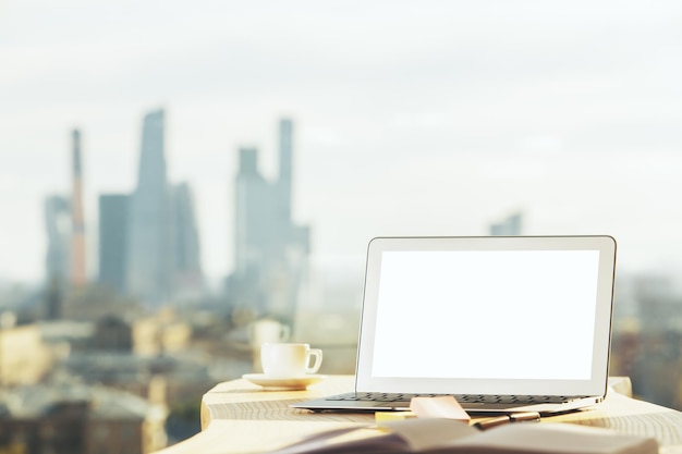 Modern desktop with blank laptop