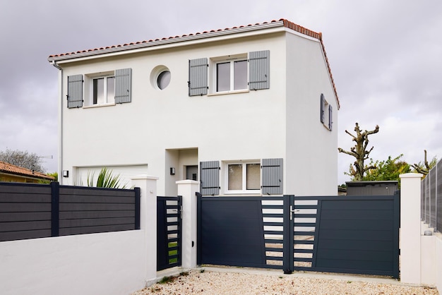 Modern detached storey house with metal gate grey fence on suburb street home