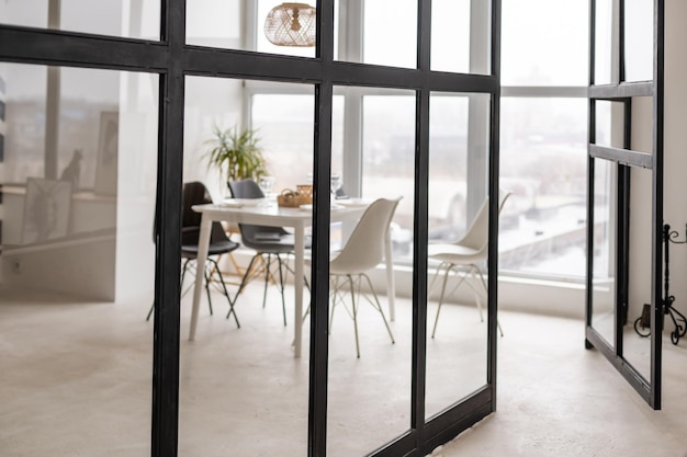 Modern dining room with big white wall.