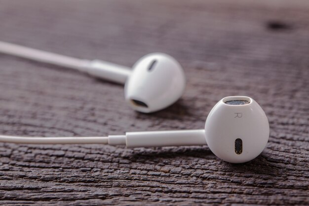 Modern earphone on wooden background