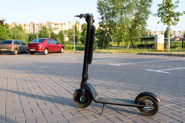 Modern electric scooter on the city road Ecological transport