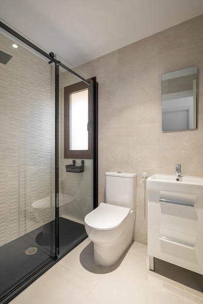 Modern empty bathroom with beige tiles furniture and rectangular mirror