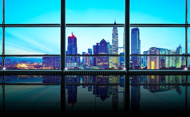 Modern empty and clean office interior with glass windows Kuala Lumpur city skyline background early morning scene