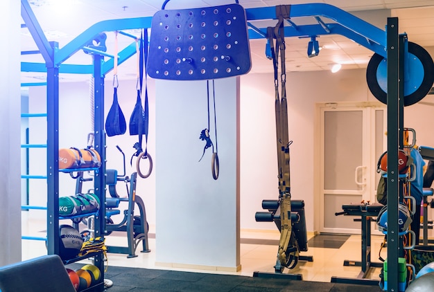 Modern equipment for doing sport exercises in the light gym.