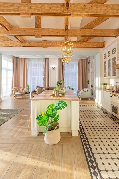 Modern expensive luxurious open-plan apartment. Rich Scandinavian-style interior with wooden beams on the ceiling in pastel colors