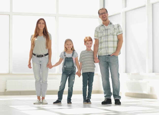 Modern family standing in a new apartmentphoto with copy space