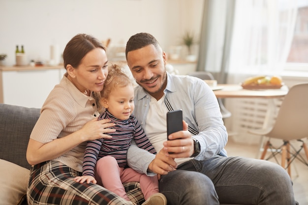 Photo modern family taking selfie at home