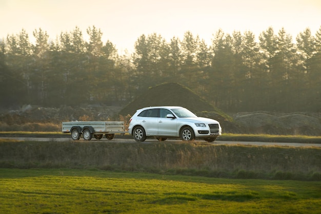Modern family vehicle pulling cargo trailer in scenic area