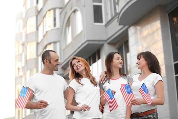 Modern family with USA flags outdoors