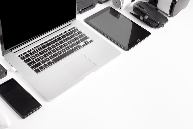 Modern gadgets on a white background, laid out diagonally, the concept of devices in the workplace