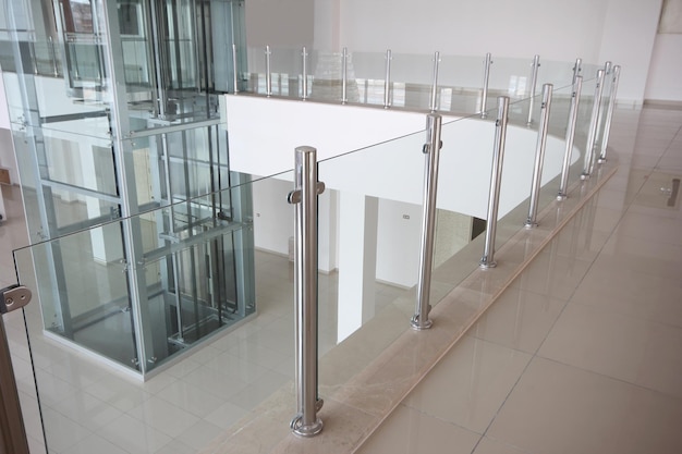 Modern glass elevator and glass railings