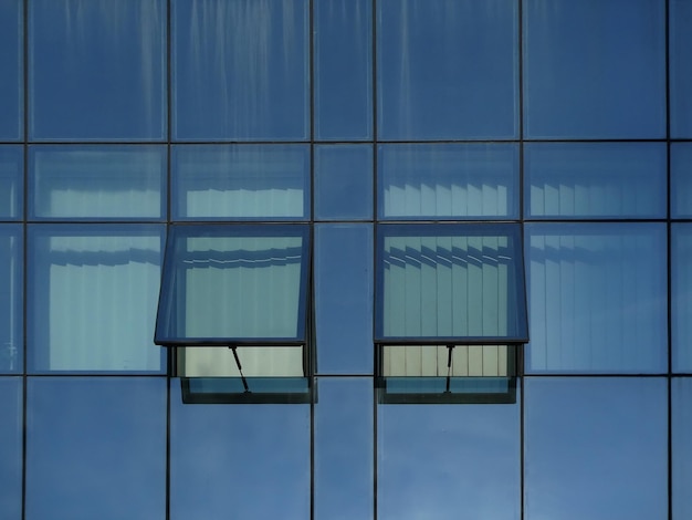 Modern glass with two opened windows view from bellow