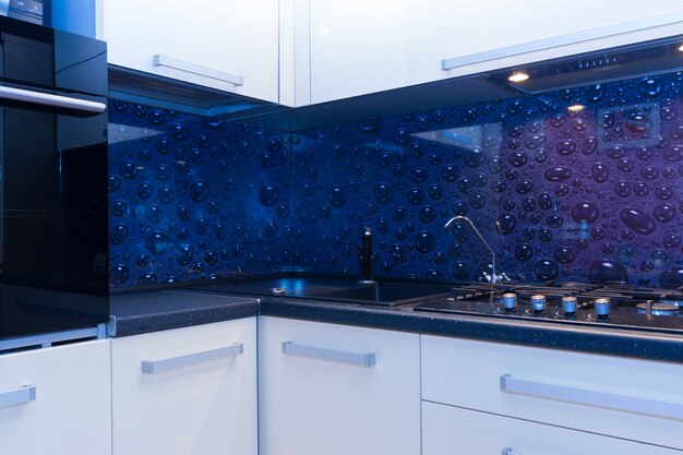 Modern glossy kitchen worktop with sink close up