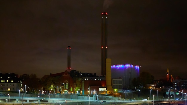 Modern grain terminal at night Metal tanks of elevator Graindrying complex construction Commercial grain or seed silos at seaport Steel storage for agricultural harvest