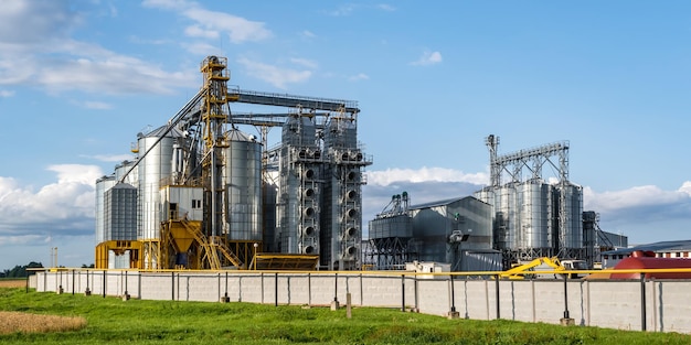 Modern Granary elevator and seed cleaning line Silver silos on agroprocessing and manufacturing plant for storage and processing drying cleaning of agricultural products flour cereals and grain