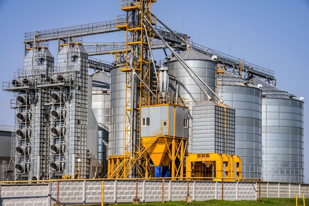 Modern granary elevator silver silos on agroprocessing and\
manufacturing plant for processing drying cleaning and storage of\
agricultural products flour cereals and grain seed cleaning\
line