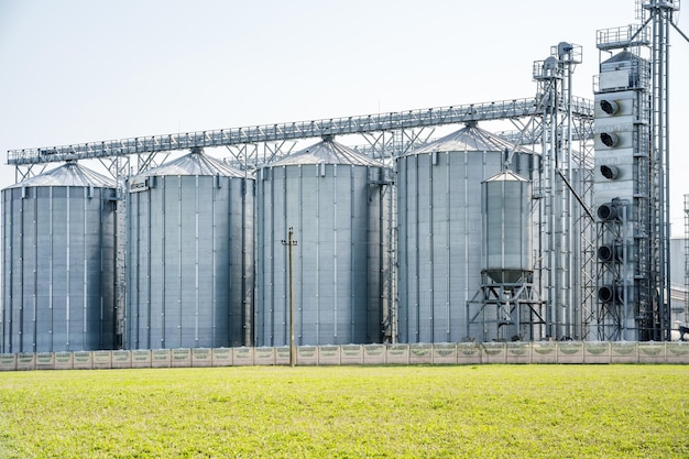 Modern Granary elevator Silver silos on agroprocessing and manufacturing plant for processing drying cleaning and storage of agricultural products flour cereals and grain seed cleaning line