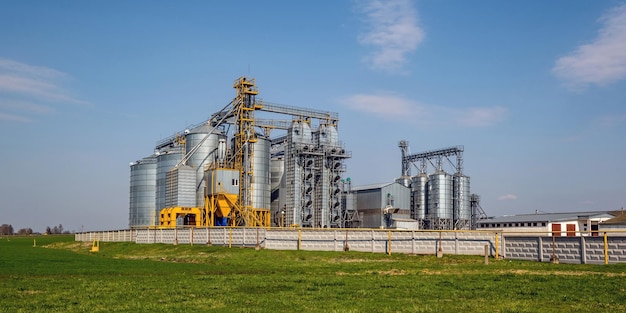 Modern granary elevator silver silos on agroprocessing and\
manufacturing plant for processing drying cleaning and storage of\
agricultural products flour cereals and grain seed cleaning\
line