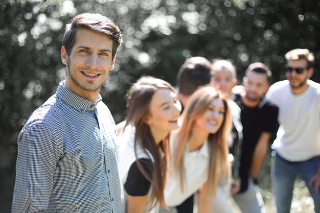 Modern guy on the background of his friends photo with space for text