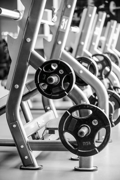 Modern gym interior with bench press equipment in a raw