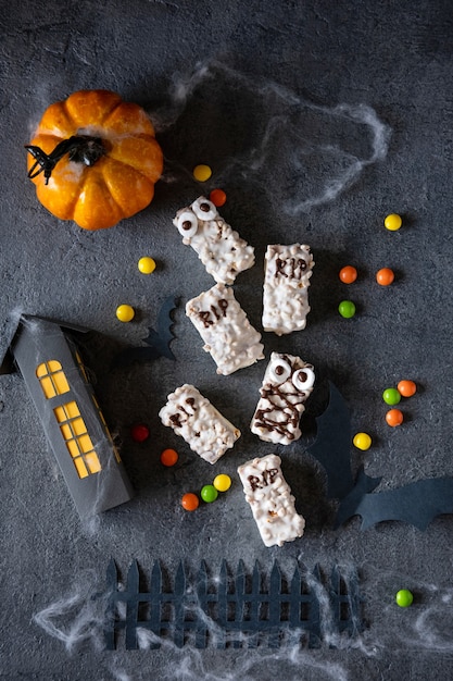 Modern Halloween background. Halloween cookies. Funny monsters made of biscuits with chocolate on the table