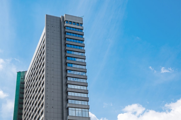 modern high-rise building made of glass against the sky