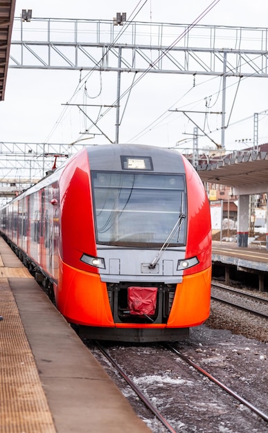 Modern highspeed train moves fast along the platform people are
waiting for train at the station