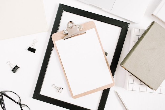 modern home office desktop with clipboard, pen, book