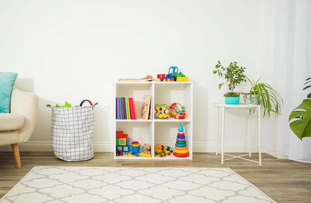 Modern interior of children's room suitable for different ages Minimalistic design for toys and books storage Light carpet on wooden floor