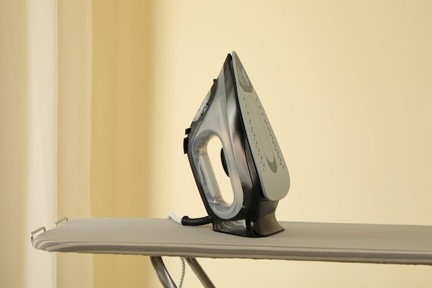 Modern iron on ironing board, space for text