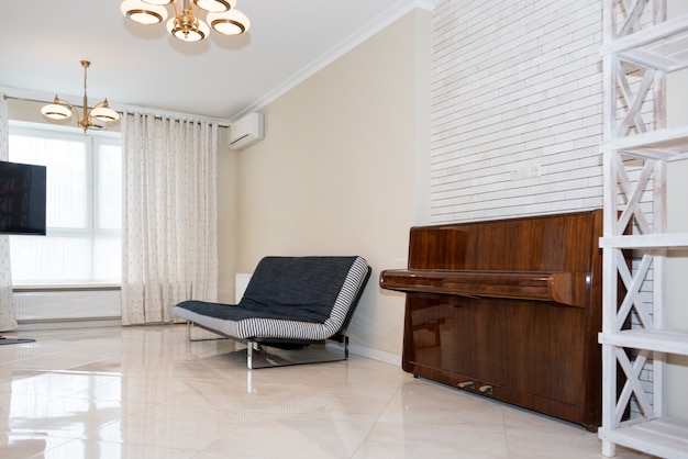 Modern kitchen area attached to the living room. Interior design with classic or vintage and modern elements.