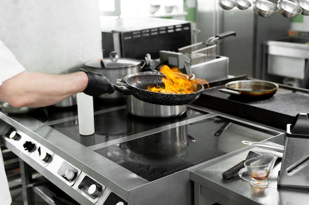 Modern kitchen Cooks prepare meals on the stove in the kitchen of the restaurant or hotel