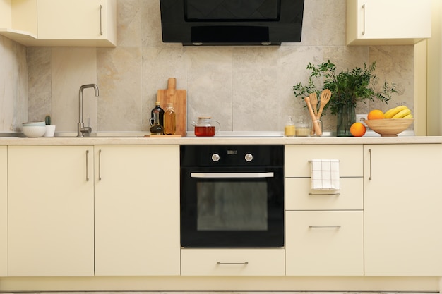 Modern kitchen interior with different supplies in light colors