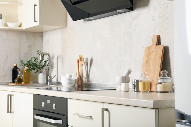 Modern kitchen interior with different supplies in light colors